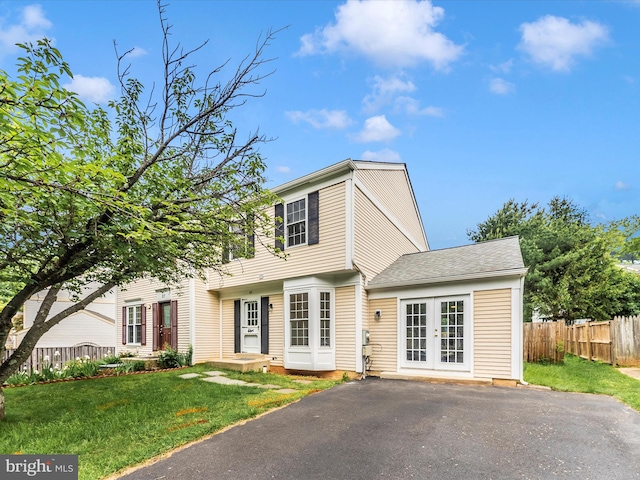 colonial house with french doors and a shingled roof