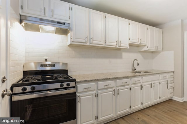 5415 Cynthia Ter, Baltimore, MD 21206 - kitchen with stainless steel gas stove, a sink, under cabinet range hood, and white cabinets