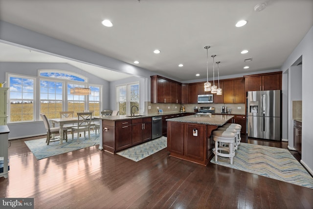 734 Holden Rd, Frederick, MD 21701 - kitchen featuring appliances with stainless steel finishes, a sink, a center island, dark wood finished floors, and light stone counters