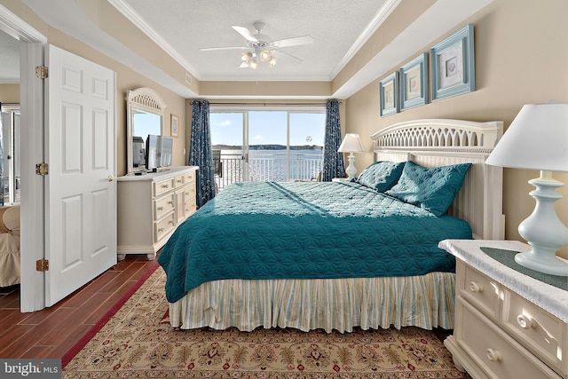 bedroom with access to exterior, ornamental molding, dark wood-type flooring, a textured ceiling, and a ceiling fan