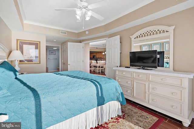 bedroom featuring crown molding, dark wood finished floors, and ceiling fan