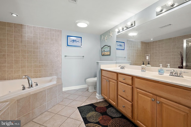 full bathroom with tile patterned floors, a bath, double vanity, toilet, and baseboards