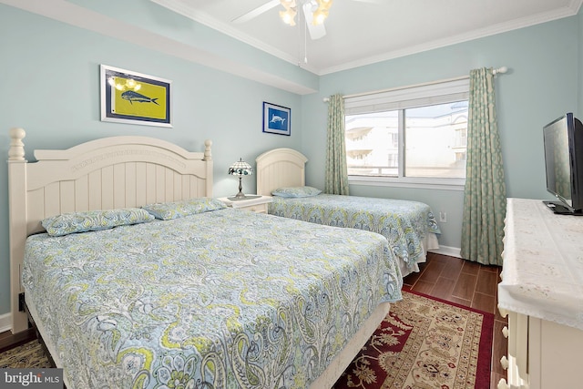 bedroom with dark wood-type flooring, ornamental molding, baseboards, and a ceiling fan
