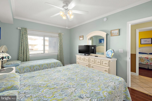 bedroom with wood finished floors, ornamental molding, ceiling fan, and baseboards