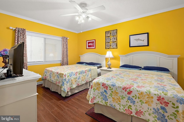 bedroom with crown molding, dark wood finished floors, and a ceiling fan