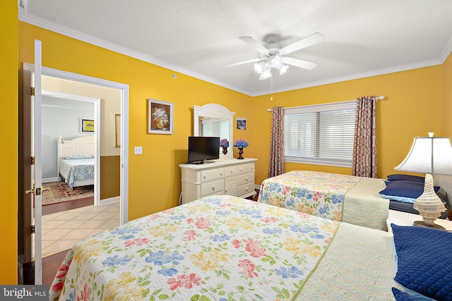 bedroom with ornamental molding, light tile patterned floors, a ceiling fan, and baseboards