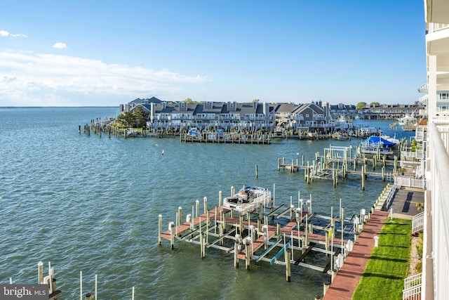 dock area with boat lift and a water view