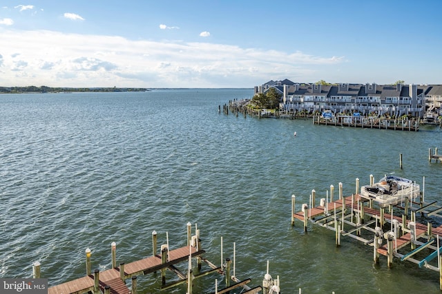 dock area featuring boat lift and a water view