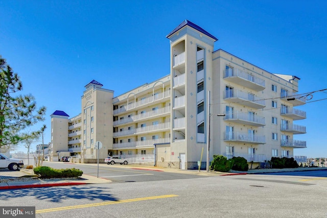 view of apartment building / complex featuring uncovered parking