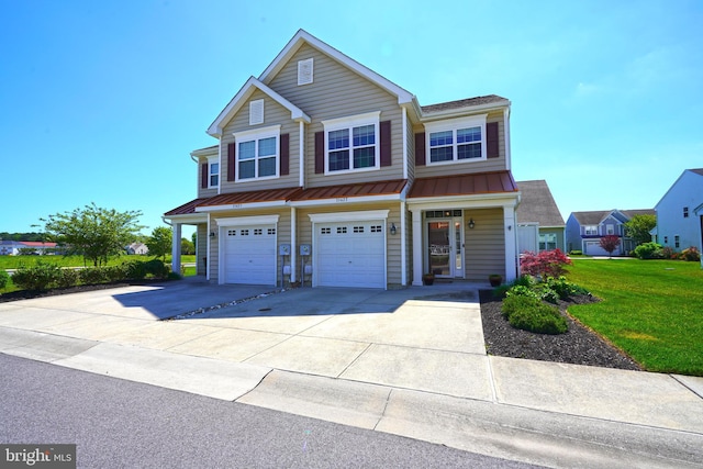35427 Mercury Dr Unit 47B, Rehoboth Beach, DE 19971 - view of front of house featuring driveway, a standing seam roof, a garage, a front yard, and metal roof