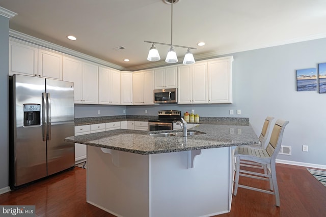 35427 Mercury Dr Unit 47B, Rehoboth Beach, DE 19971 - kitchen featuring stainless steel appliances, a sink, a peninsula, dark stone countertops, and dark wood-style floors