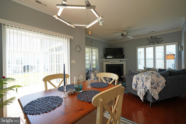 35427 Mercury Dr Unit 47B, Rehoboth Beach, DE 19971 - dining area featuring wood finished floors, a fireplace, crown molding, and a ceiling fan