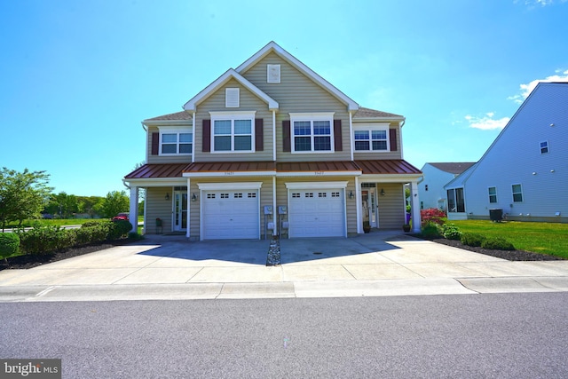 35427 Mercury Dr Unit 47B, Rehoboth Beach, DE 19971 - view of front of home featuring an attached garage, concrete driveway, a standing seam roof, and metal roof