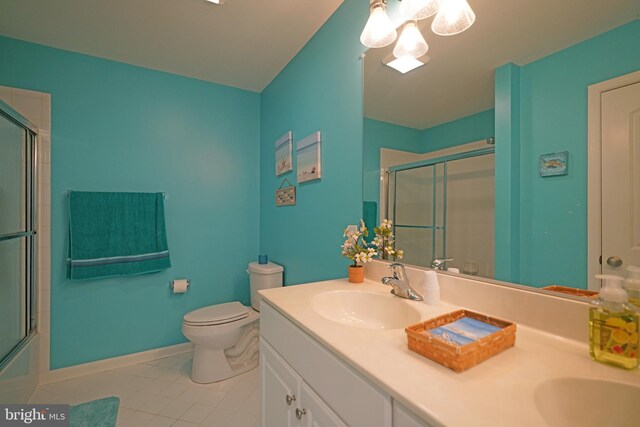 35427 Mercury Dr Unit 47B, Rehoboth Beach, DE 19971 - full bathroom with tile patterned floors, double vanity, toilet, baseboards, and a chandelier
