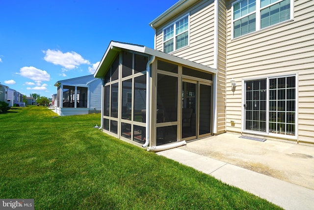 35427 Mercury Dr Unit 47B, Rehoboth Beach, DE 19971 - rear view of house featuring a sunroom, a patio area, and a yard