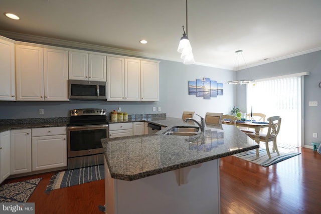 35427 Mercury Dr Unit 47B, Rehoboth Beach, DE 19971 - kitchen with stainless steel appliances, a sink, white cabinetry, crown molding, and a breakfast bar