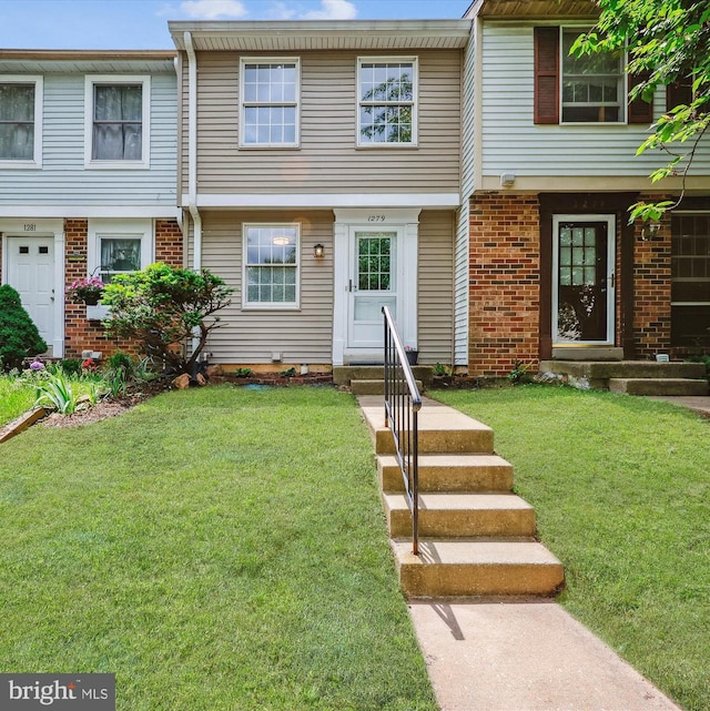 1279 Elm Grove Cir, Silver Spring, MD 20905 - townhome / multi-family property with brick siding and a front lawn