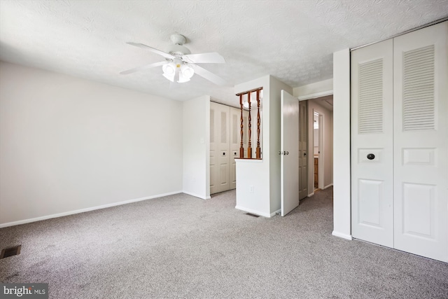 1279 Elm Grove Cir, Silver Spring, MD 20905 - unfurnished bedroom featuring carpet floors, two closets, baseboards, a ceiling fan, and a textured ceiling