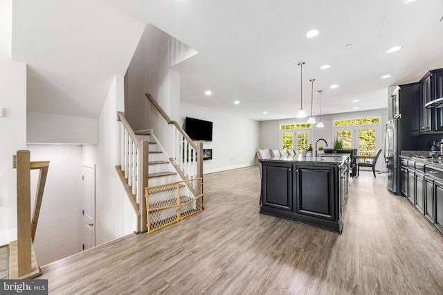 2660 Richmond Way, Hanover, MD 21076 - kitchen with appliances with stainless steel finishes, light wood-type flooring, dark cabinets, a kitchen island with sink, and recessed lighting