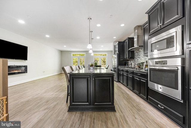 2660 Richmond Way, Hanover, MD 21076 - kitchen with appliances with stainless steel finishes, wall chimney range hood, dark cabinetry, a sink, and recessed lighting