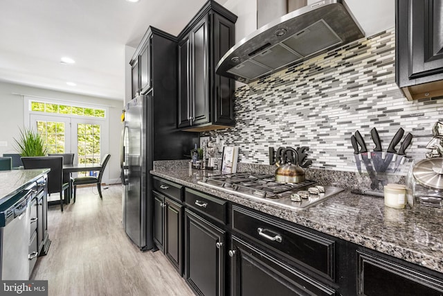 2660 Richmond Way, Hanover, MD 21076 - kitchen featuring exhaust hood, dark cabinetry, tasteful backsplash, appliances with stainless steel finishes, and light wood finished floors