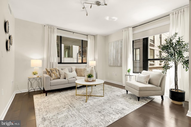 living area featuring dark wood-style floors and baseboards