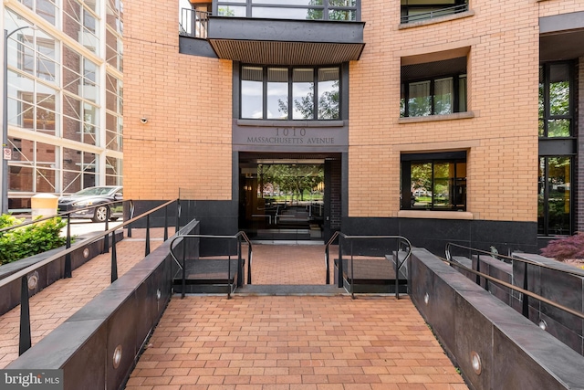 view of exterior entry featuring brick siding