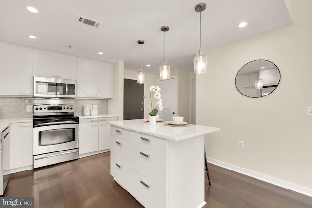 kitchen with appliances with stainless steel finishes, dark wood finished floors, tasteful backsplash, white cabinetry, and light countertops