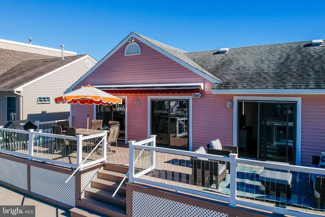 28 Diane Rd, Manahawkin, NJ 08050 - rear view of house featuring a wooden deck, a shingled roof, and outdoor dining space