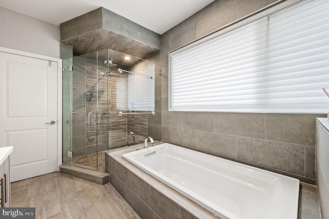 307 Reed St Unit C, Philadelphia, PA 19147 - full bath with a shower stall, a garden tub, tile patterned flooring, tile walls, and vanity