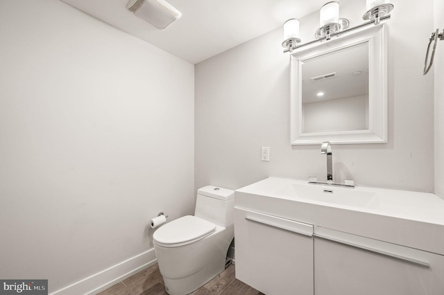 307 Reed St Unit C, Philadelphia, PA 19147 - half bath featuring wood finished floors, toilet, vanity, and baseboards