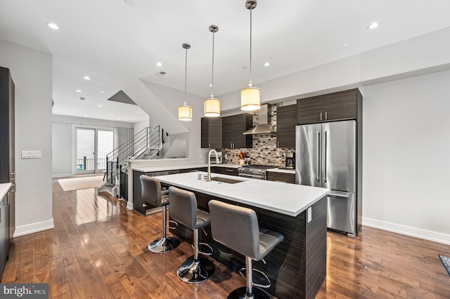 307 Reed St Unit C, Philadelphia, PA 19147 - kitchen featuring high end appliances, a sink, light countertops, wall chimney range hood, and recessed lighting