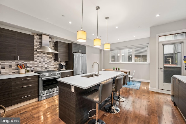 307 Reed St Unit C, Philadelphia, PA 19147 - kitchen with wall chimney range hood, a sink, stainless steel appliances, modern cabinets, and recessed lighting