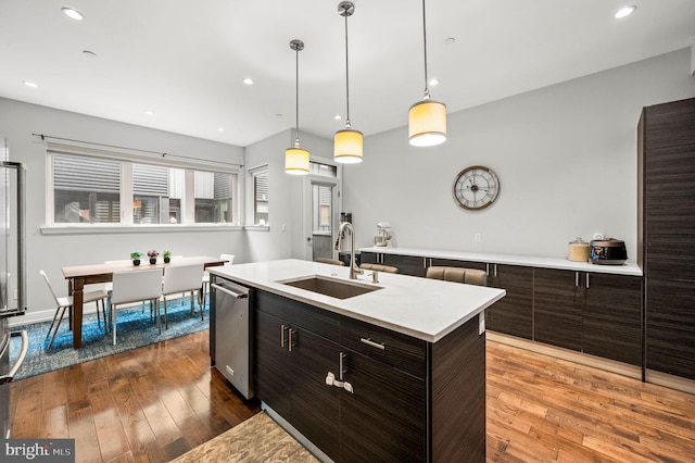 307 Reed St Unit C, Philadelphia, PA 19147 - kitchen with a sink, stainless steel dishwasher, light countertops, hardwood / wood-style floors, and an island with sink