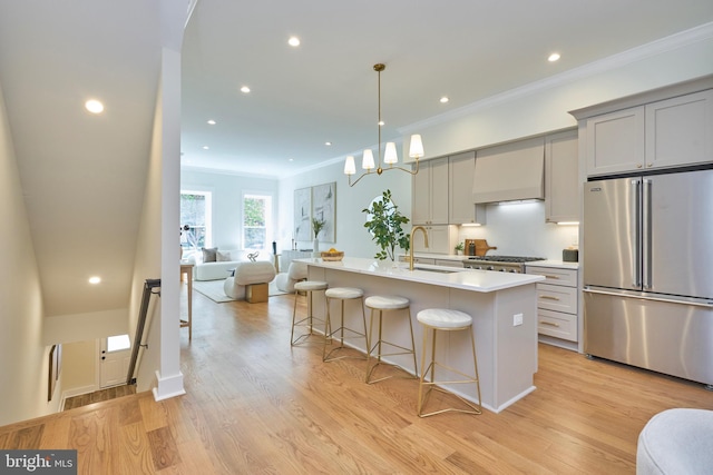 309 M St NW Unit B, Washington, DC 20001 - kitchen featuring high end refrigerator, gray cabinetry, open floor plan, a kitchen bar, and ornamental molding