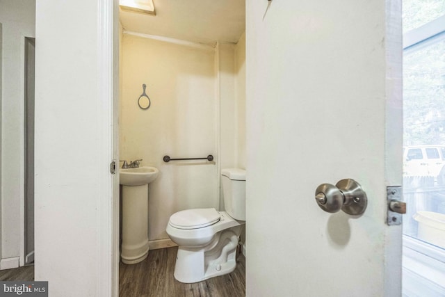 bathroom featuring wood finished floors and toilet