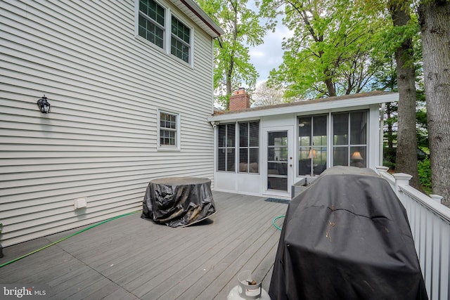 deck featuring a sunroom and grilling area