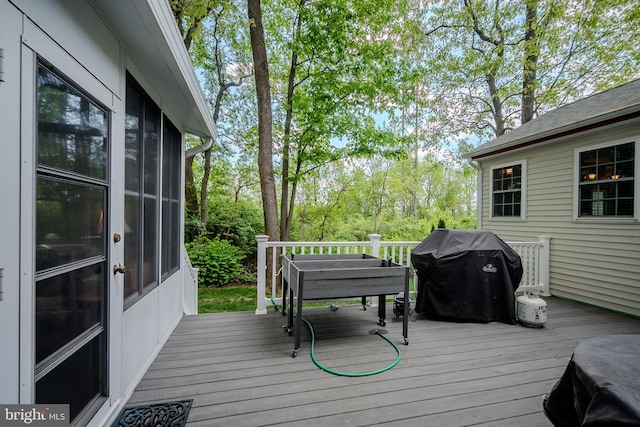 wooden deck with a grill