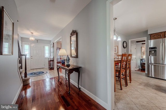 entrance foyer with baseboards and light wood-type flooring