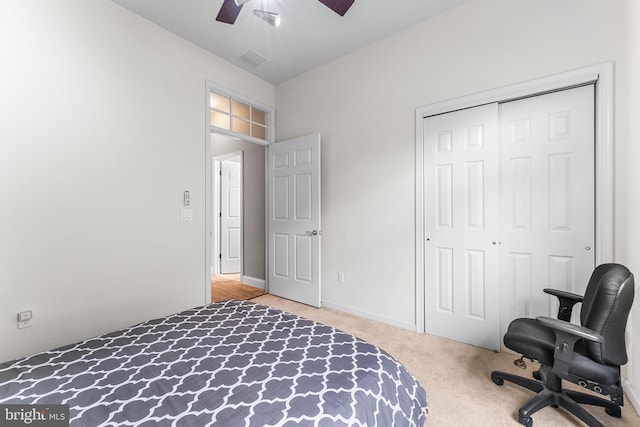 carpeted bedroom with a closet and ceiling fan