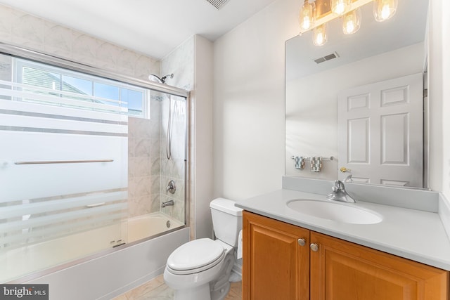 bathroom featuring toilet, vanity, and combined bath / shower with glass door