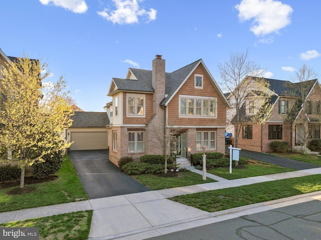 23325 April Mist Pl, Brambleton, VA 20148 - view of front of property featuring driveway, a garage, a front yard, a chimney, and brick siding