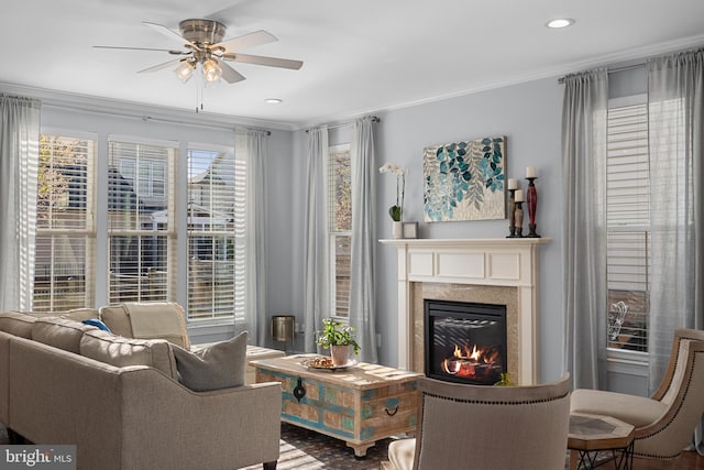 23325 April Mist Pl, Brambleton, VA 20148 - living area featuring ornamental molding, a ceiling fan, a glass covered fireplace, and recessed lighting