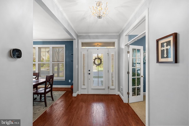 23325 April Mist Pl, Brambleton, VA 20148 - entrance foyer featuring a chandelier, wood finished floors, baseboards, plenty of natural light, and crown molding