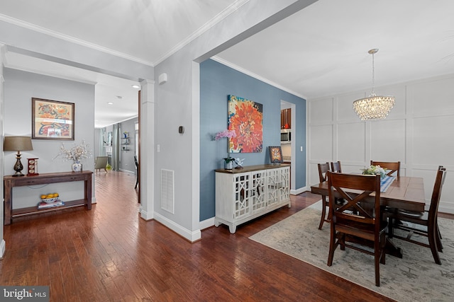 23325 April Mist Pl, Brambleton, VA 20148 - dining space featuring a chandelier, wood finished floors, ornamental molding, baseboards, and a decorative wall