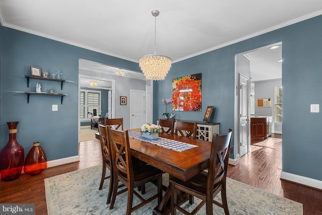 23325 April Mist Pl, Brambleton, VA 20148 - dining room featuring baseboards, a chandelier, crown molding, and wood finished floors