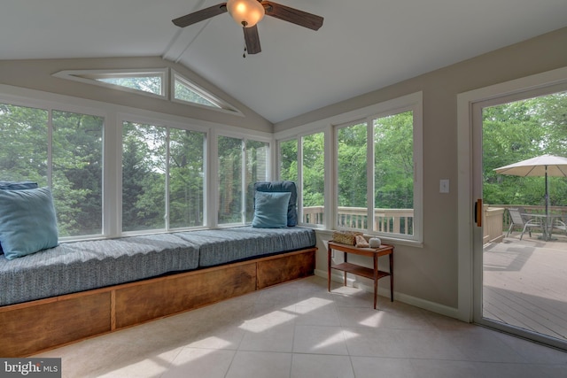 sunroom / solarium with lofted ceiling, tile patterned floors, and baseboards