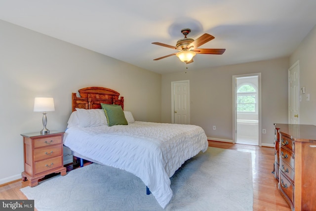 bedroom featuring light wood-style flooring, baseboards, and a ceiling fan