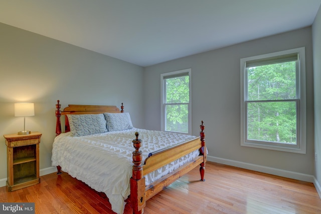 bedroom featuring baseboards and light wood-style flooring