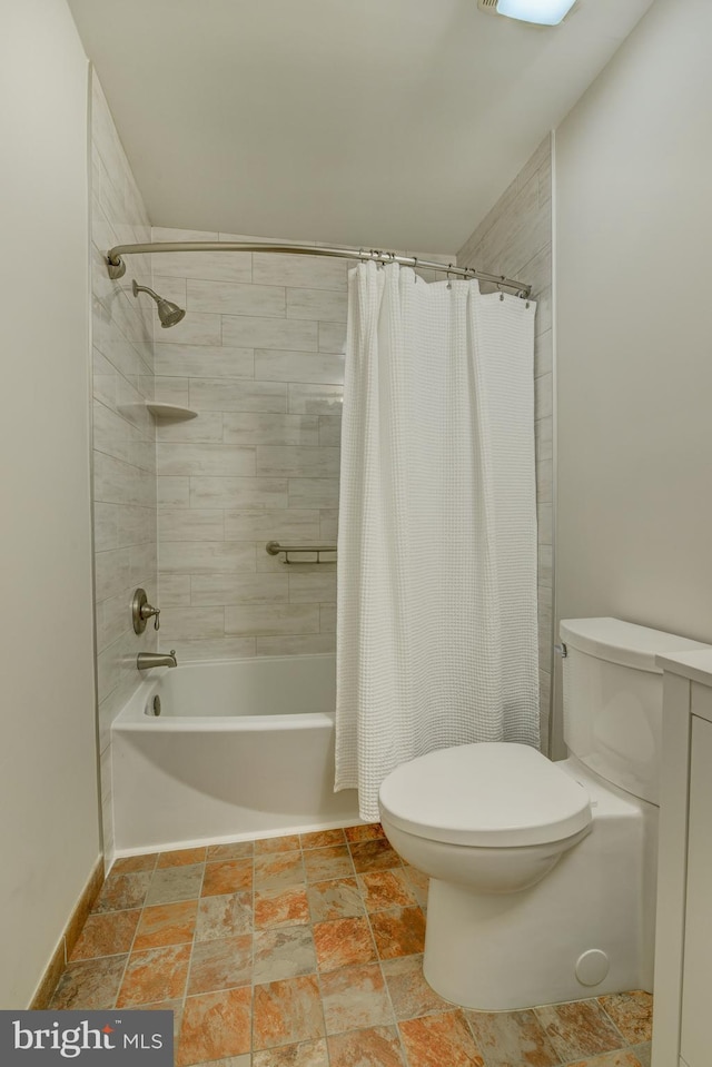bathroom with toilet, stone tile flooring, and shower / bathtub combination with curtain